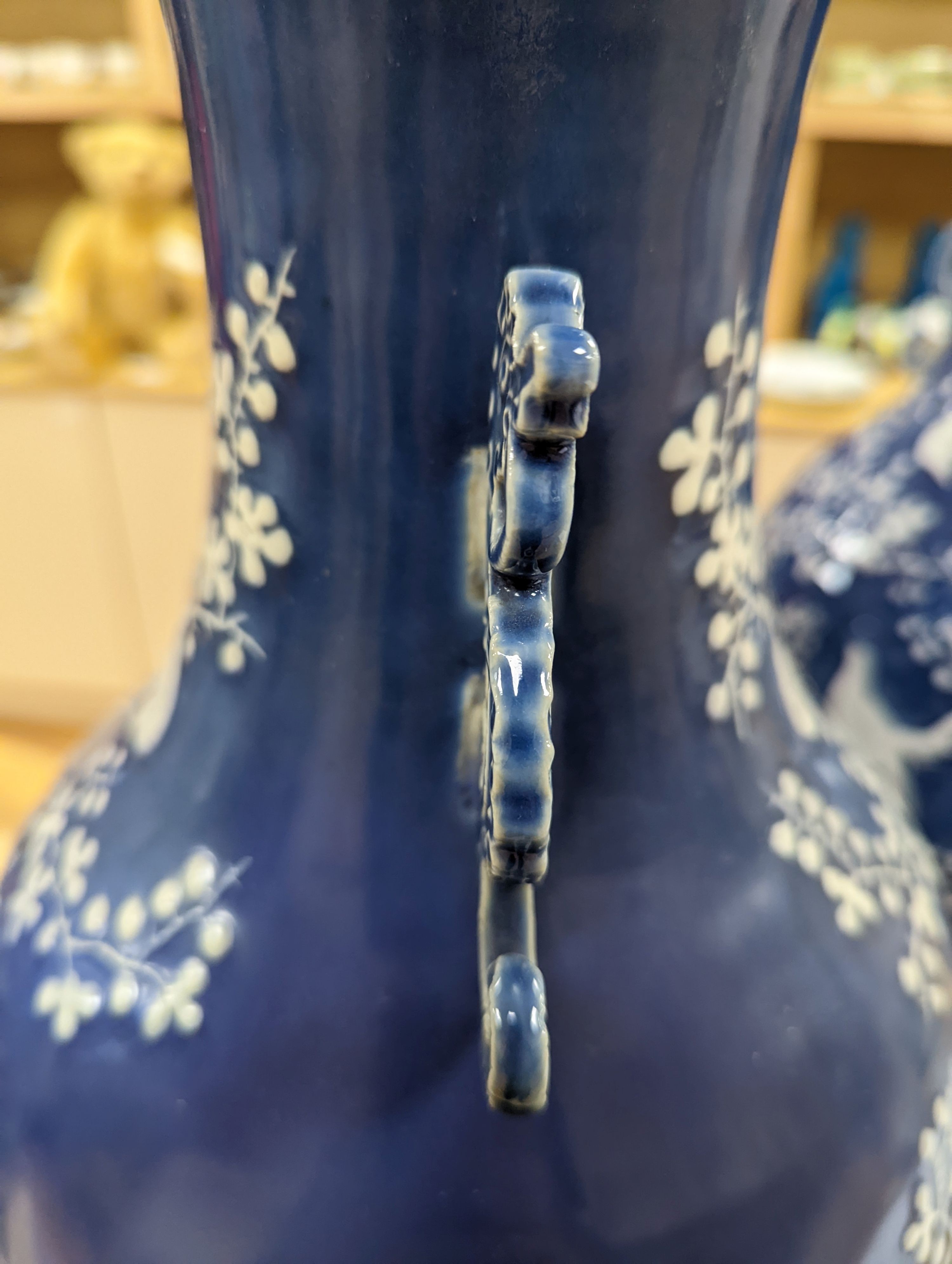 A pair of large 19th century Chinese slip decorated blue ground vases, restored, 59cm